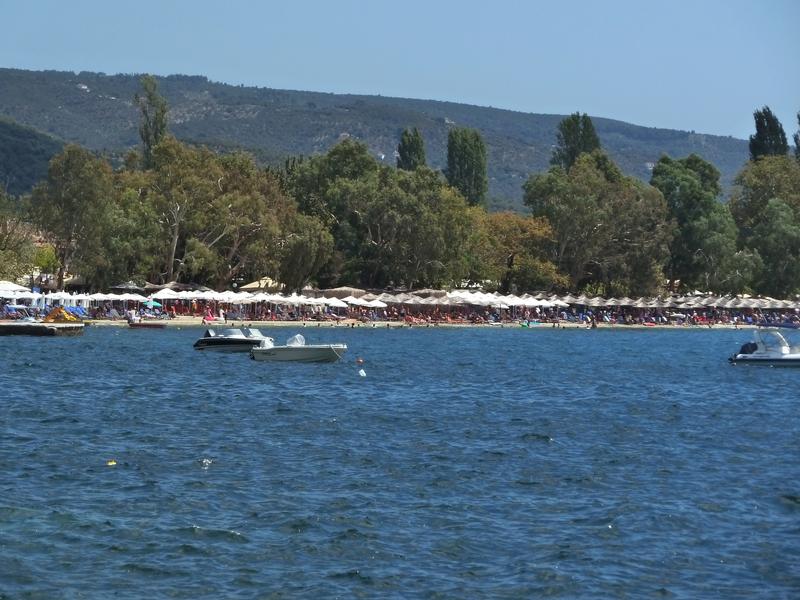 Small boats and swimmers in Kala Nera beach