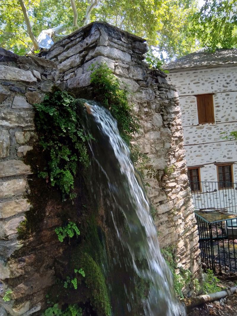 Running water on a stone wall in Makrinitsa