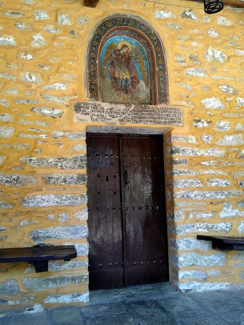 Notiable hagiography over the wooden door of the Church of Pammeghistoi Taxiarhes in Milies